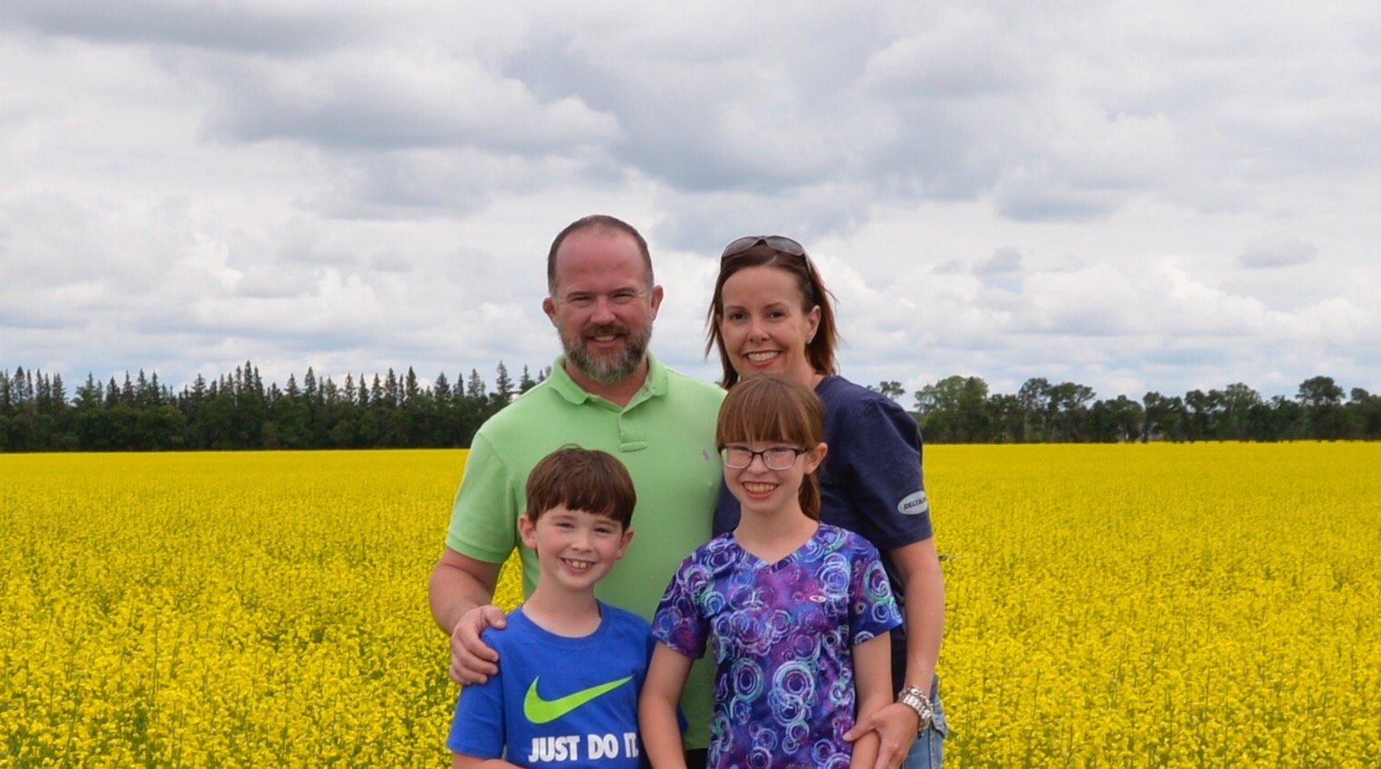 Jon Riley and family in a canola field in Canada